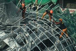 Philippines races to rescue people trapped in a building collapse; a Malaysian among the dead