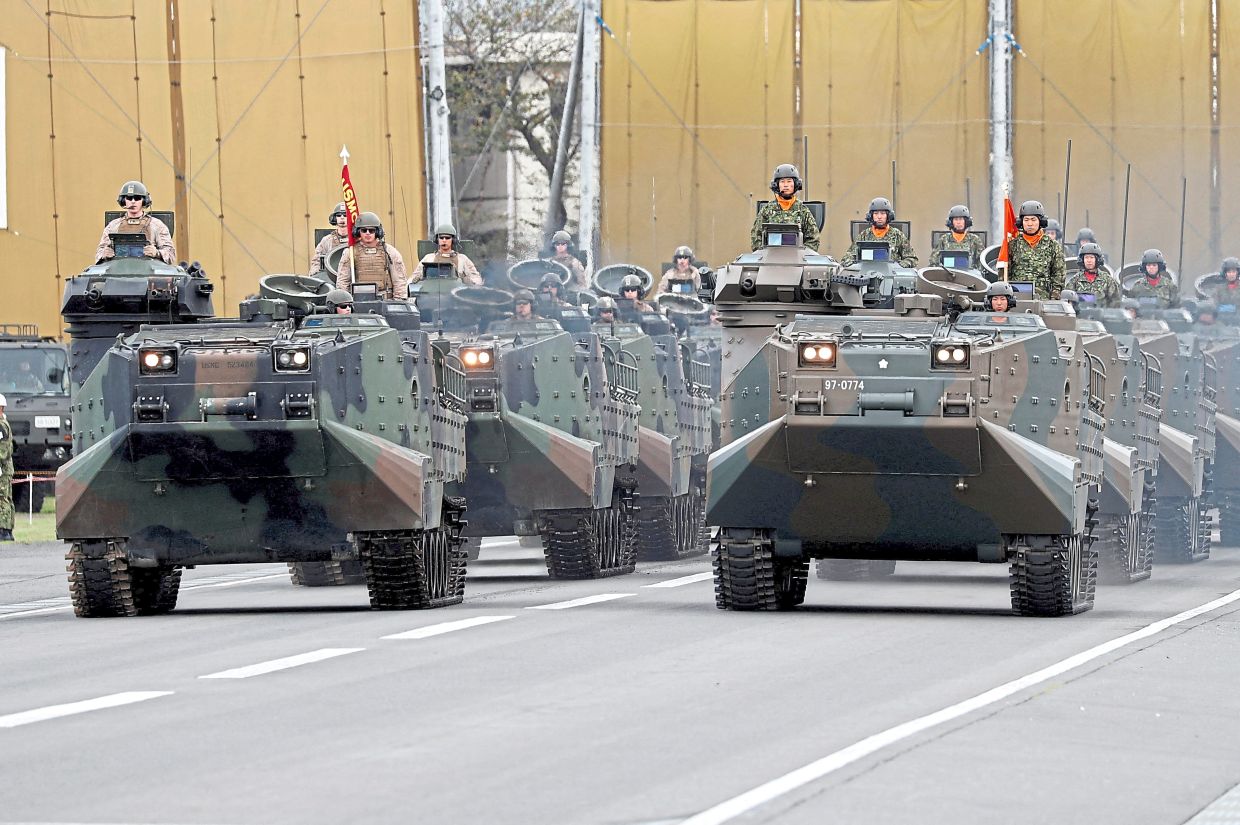 A file photo of US Marine Corps and Japanese Self-Defence Force military vehicles on parade at Asaka Base, north of Tokyo on Oct 14, 2018. — Reuters