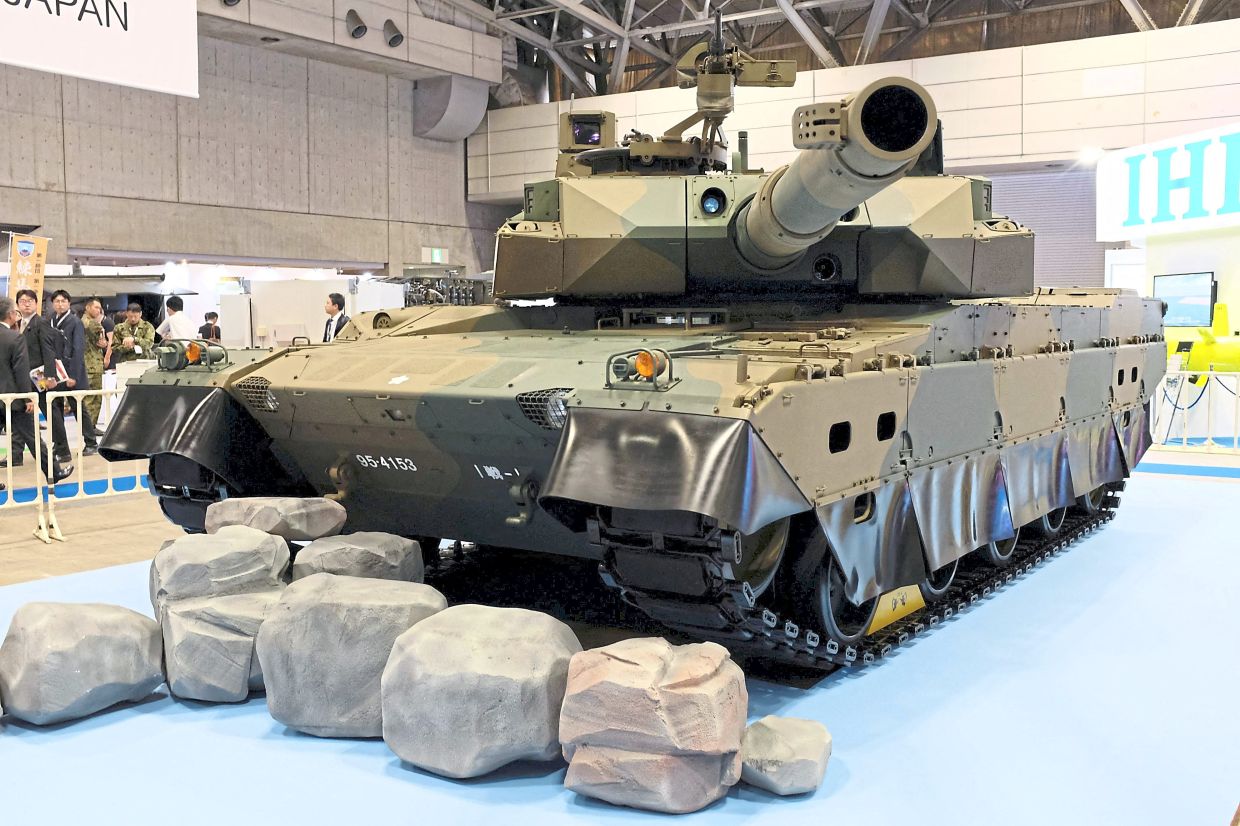 A Japanese Type 10 tank displayed at DSEI Japan; and