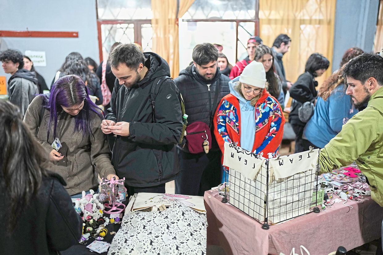 People look at stands selling rat merchandise.