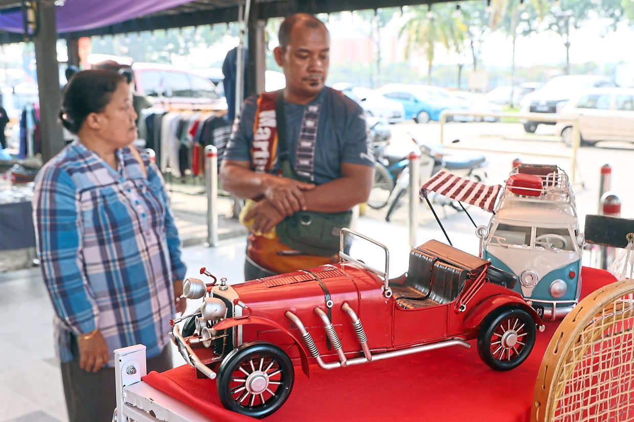 Elaborate toy cars are among the items sold at the flea market.