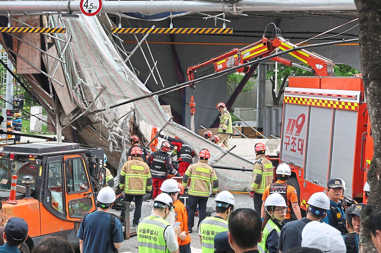 South Korean firefighters and rescue team try to search at the overpass collapsed while it was being dismantled in Seoul, South Korea, Tuesday, May 26, 2026. (Lee Ji-eun/Yonhap via AP)