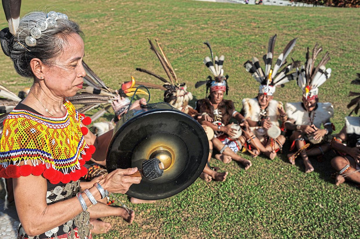 Doris striking the tawak as part of the gendang pampat ensemble.