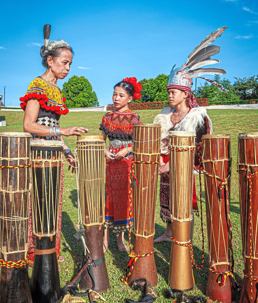 Doris (left) hopes Roshilda (centre) and Xander will carry forward the ngajat tradition, keeping the cultural heritage alive for future generations.