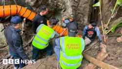Rescuers race to drain flooded Laos cave, extract trapped men
