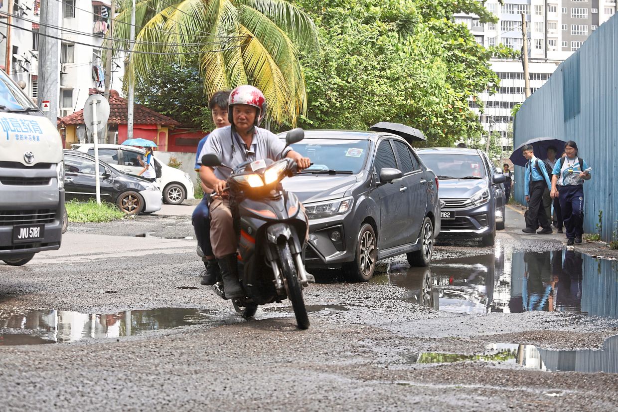 The danger hit home for Wong Zhi Hong, 30, whose car chassis was damaged when he drove his car into a massive pothole during his morning commute to work.