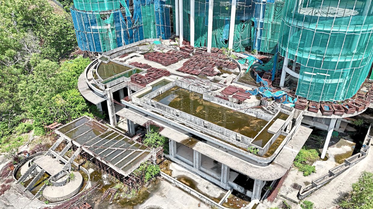 Close-up of stagnant pools of water that have formed across the unfinished decks and lower levels of the development.