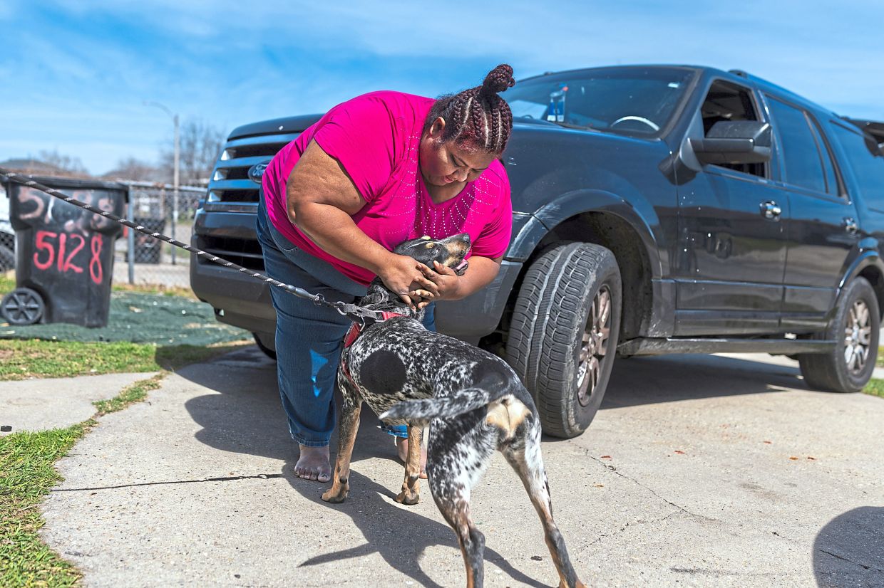 Rosales-Fajardo with her foster dog Cheddar in New Orleans. She agreed to foster Cheddar for a couple that self-deported to Honduras and hoped he would follow. However, they were unable to afford the cost to fly him there. — Kathleen Flynn/The New York Times