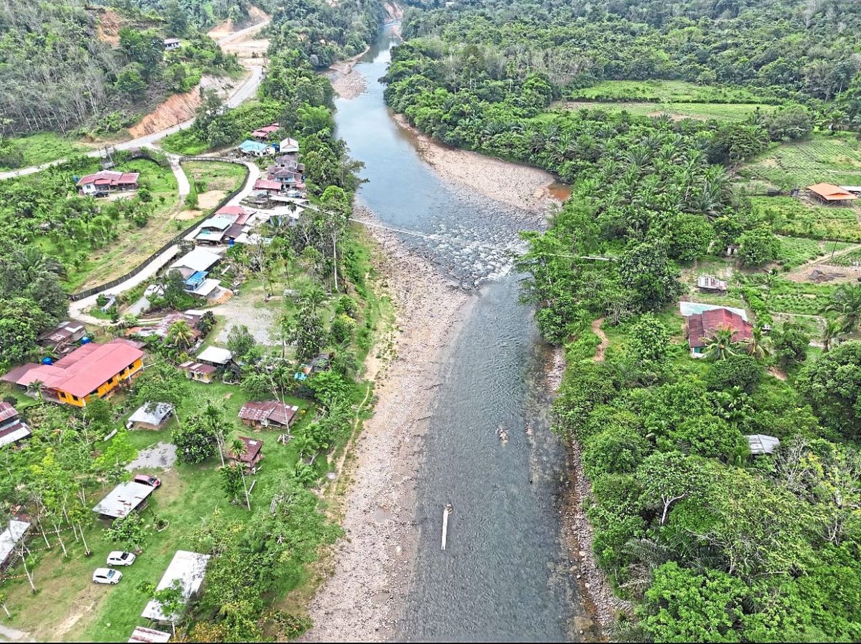 Cross the jambatan gantung for a panoramic view of Papar River. — AA Campsite Kg Bolotikon