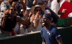 Tennis-Tiafoe makes online plea after losing racket in crowd during victory celebrations