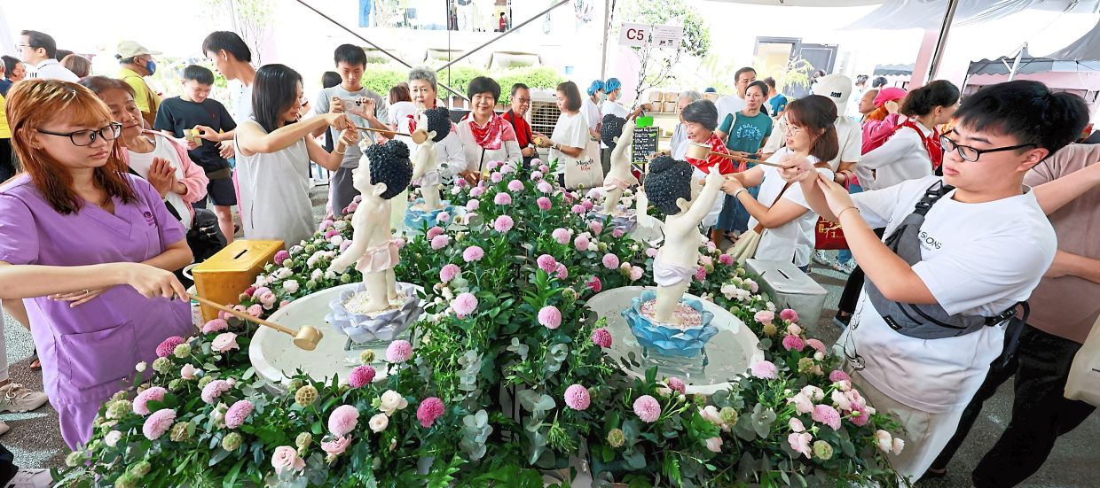Devotees bathing statues of infant Siddhartha Gautama, or the Buddha, during the Wesak Day celebration at Fo Guang Shan temple in SS5, Petaling Jaya, last year.— Courtesy of KONG CHOI MEE