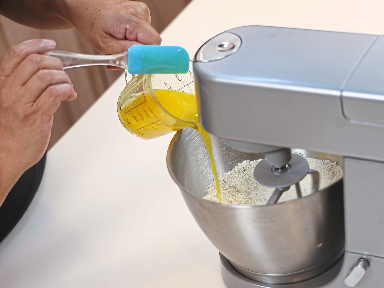 With the mixer paddle mixing the dry ingredients on low speed, drizzle in melted butter until the dough resembles fine breadcrumbs.