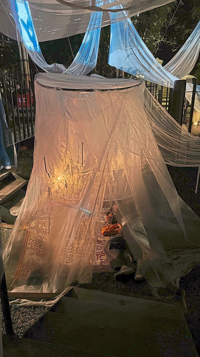 Visitors move through the maze-like bamboo structure at their own pace, including resting within the kelambu nets, while listening to recordings of dream accounts. Photo: The Star/M. Irsyad 