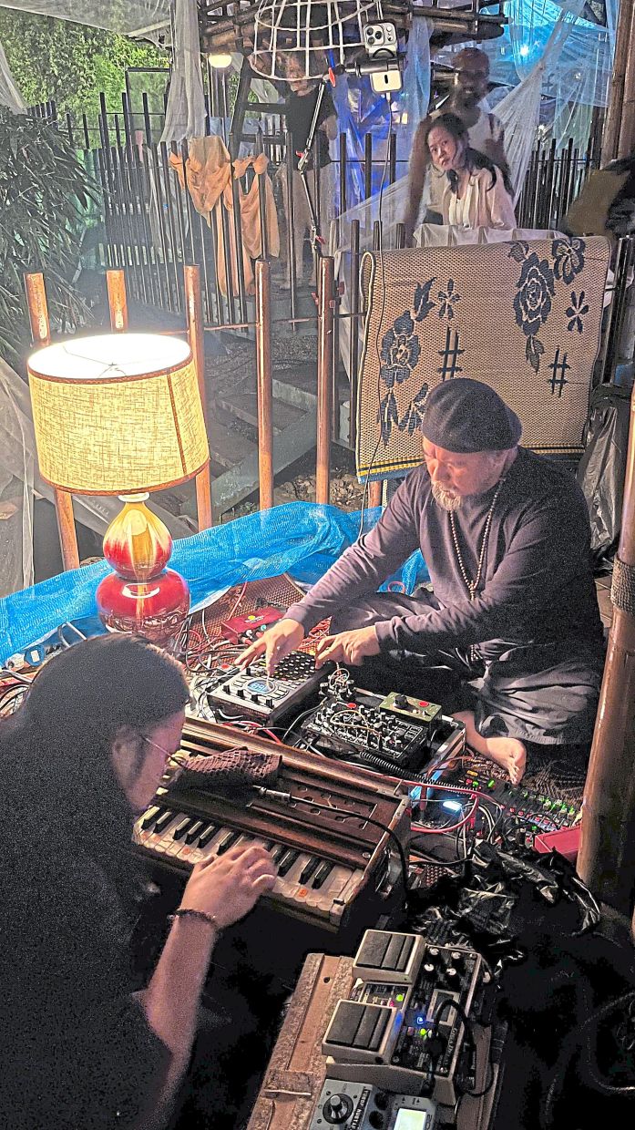 The installation is accompanied throughout by live organic electronic music from Kamal Sabran (right) and Irfan Mustafa, heightening its dreamlike quality. Photo: The Star/M. Irsyad 