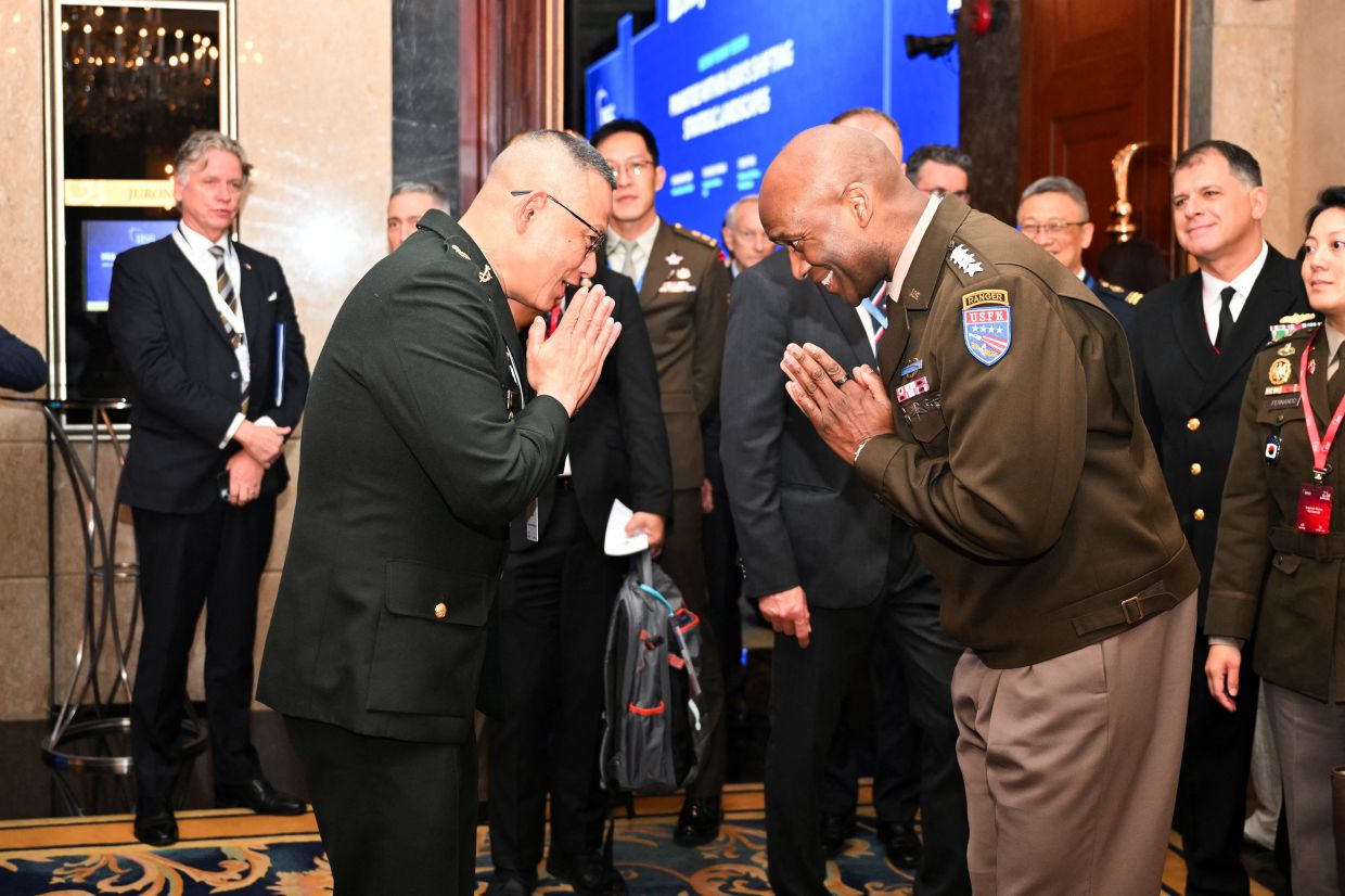 Commander of United Nations Command, Combined Forces Command, and United States Forces Korea Xavier Brunson greets a Thailand representative at the IISS Shangri-La Dialogue security summit in Singapore on Saturday, May 30, 2026. -- REUTERS/Caroline Chia