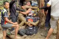 Two miners are still missing and trapped in Laos, but five have been brought to safety, say rescuers