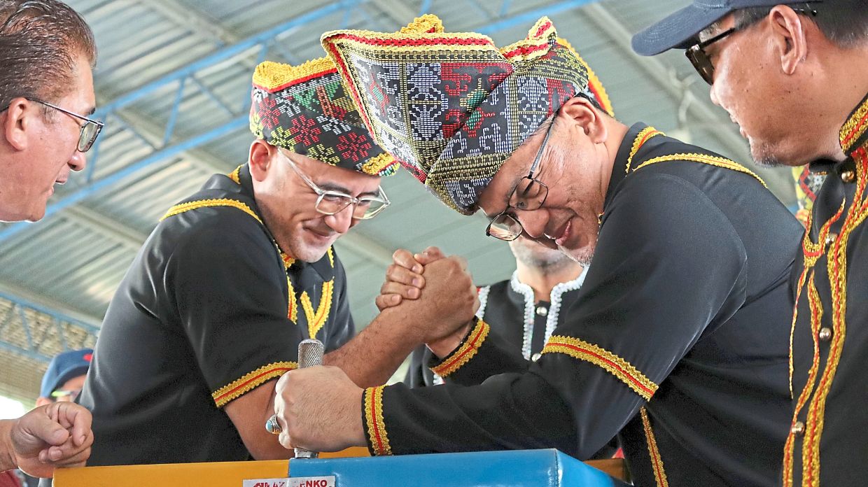 Test of strength: Nizam (right) having a go at arm wrestling. 