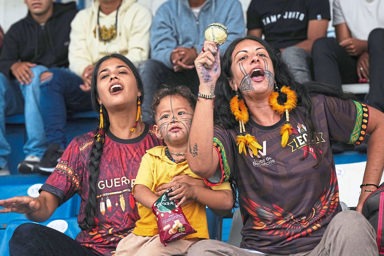 Fans cheer during the match against Barcelona.