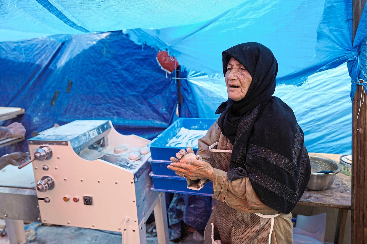 Zeiter preparing dough at a small bakery in Beirut, where she feeds displaced people in a tented settlement.