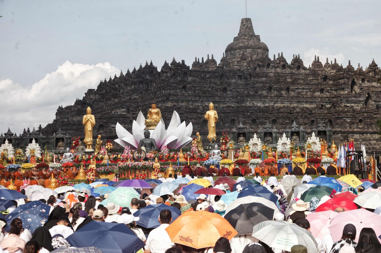 Buddhist monks and devotees participate in Wesak celebrations in front of Borobudur Temple, the world's largest Buddhist monument and a UNESCO World Heritage Site, in Magelang, Central Java, on May 31, 2026. -- Photo by Aditya Irawan / AFP