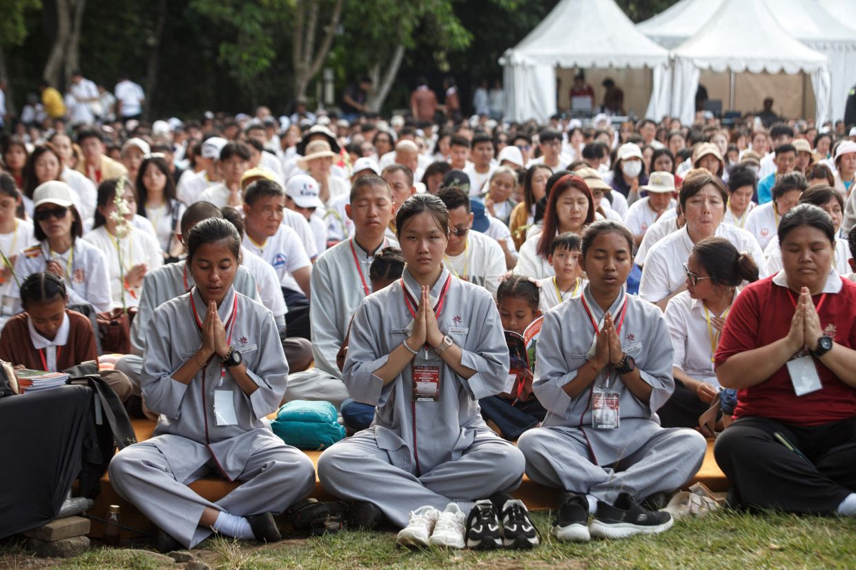 Buddhist devotees participate in Vesak celebrations in front of Borobudur Temple, the world's largest Buddhist monument and a UNESCO World Heritage Site, in Magelang, Central Java, on May 31, 2026. -- Photo by Aditya Irawan / AFP