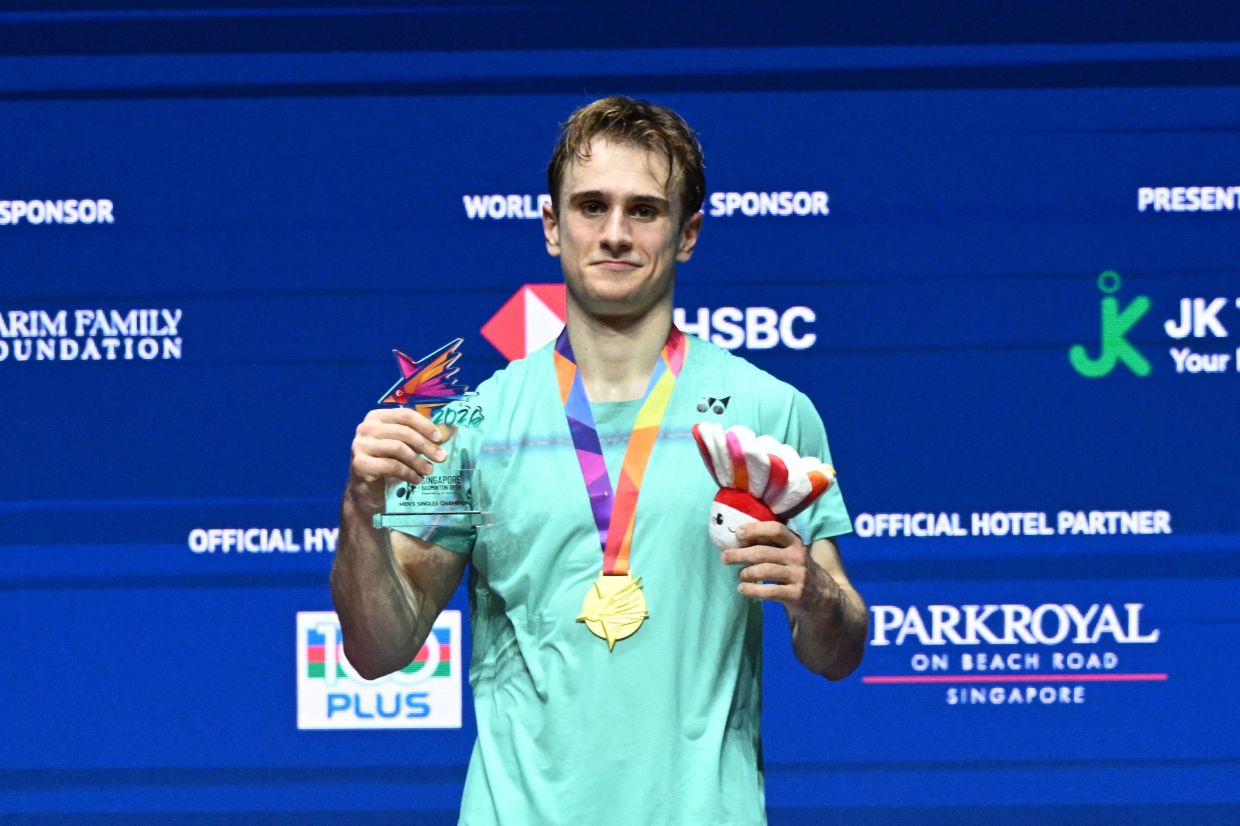 Alex Lanier of France celebrates on the podium with his medal after his victory against Loh Kean Yew of Singapore during their men's singles final match of the KFF Singapore Open Badminton tournament in Singapore on Sunday. May 31, 2026. -- Photo by Roslan RAHMAN / AFP