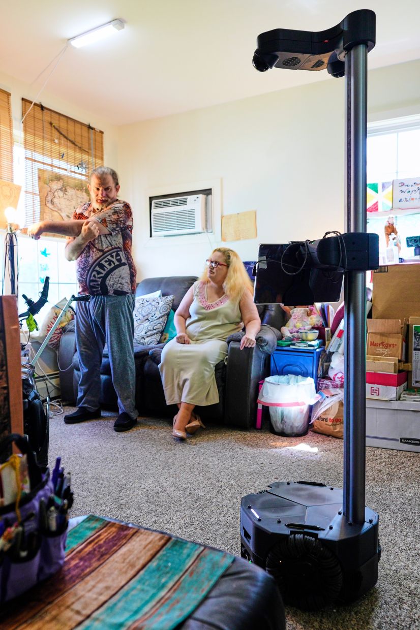 A Hello Robot gives audio and visual guidance for Brian Marquis' daily exercise routine as he recovers from a brain injury, Tuesday, April 21, 2026, in Durham, N.H.