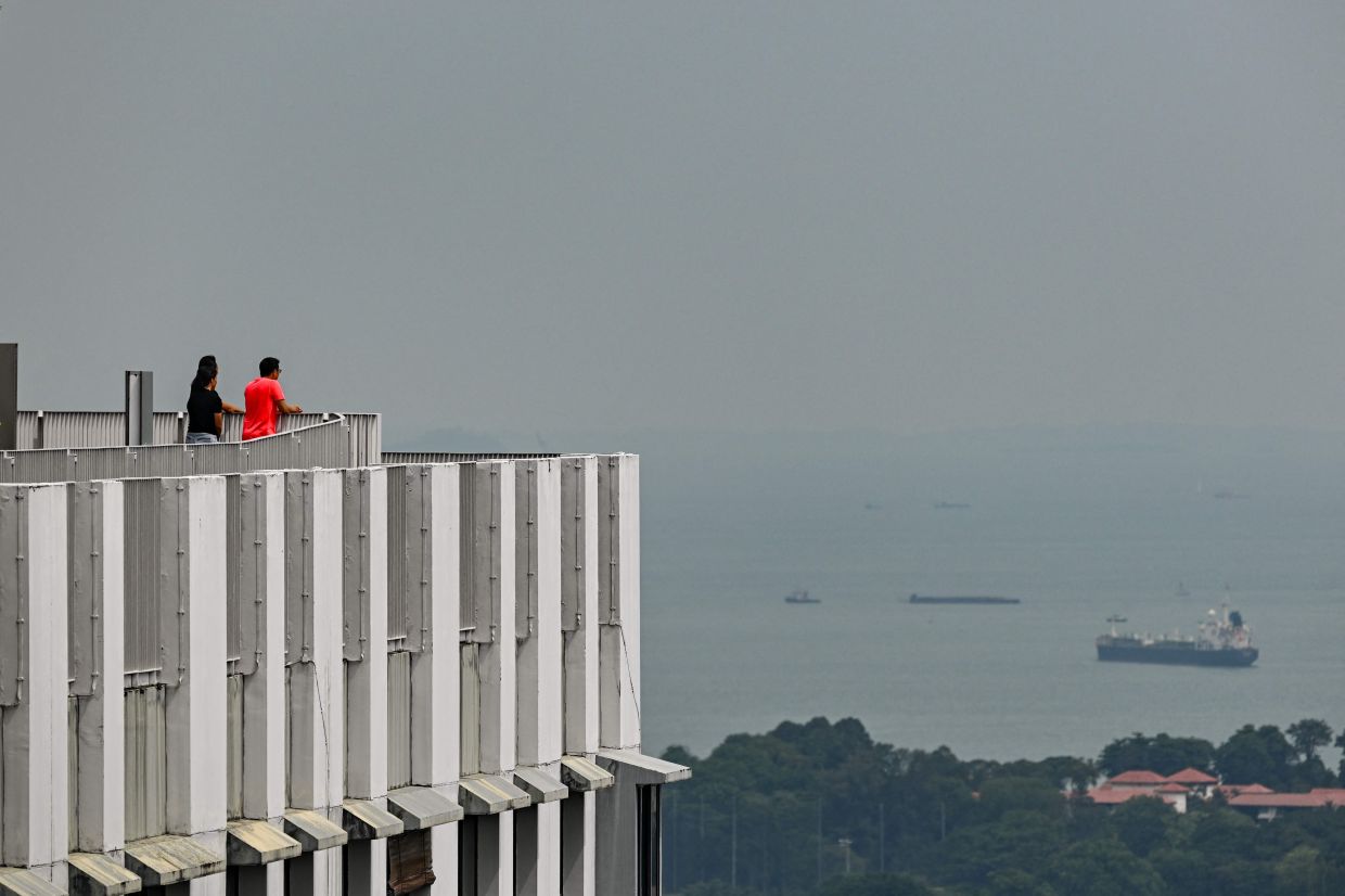 People look on from a vantage point in Singapore on Monday, June 1, 2026. -- Photo by Jam STA ROSA / AFP