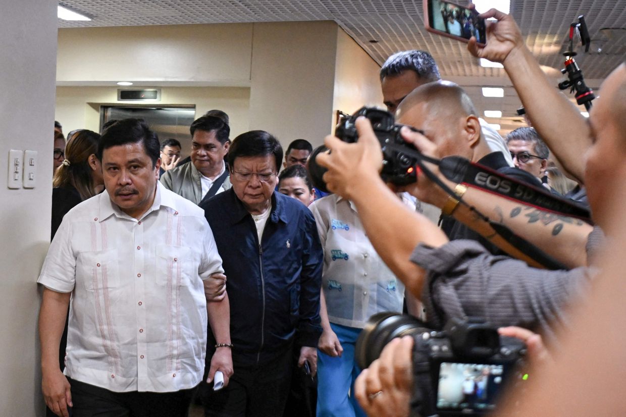 Philippine Senator Jose Jinggoy Estrada (left), accompanied by colleague Senator Rodante Marcoleta, arrives for a press conference after a warrant of arrest was served at the Senate building in Manila on June 1, 2026. A sitting Philippine senator was arrested on June 1, becoming the highest-ranking official to be detained in a massive corruption scandal over bogus flood control projects. Opposition Senator Jose Jinggoy Estrada rejected the charges against him as nonsense and a ploy to get him to switch sides in a bitterly divided Senate. -- Photo by Ted ALJIBE / AFP