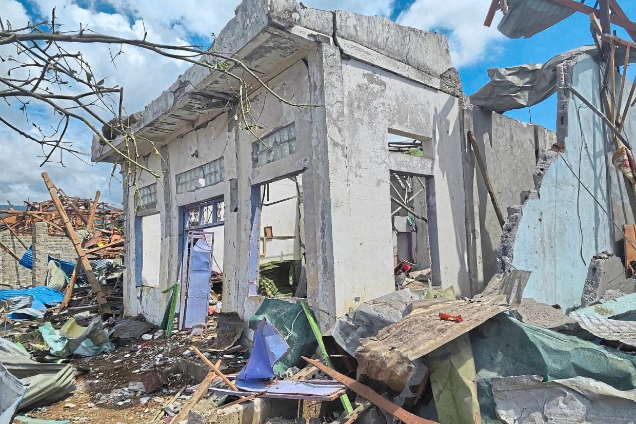 Barely standing: Buildings badly damaged after the explosion in Kaung Tat village. — AP