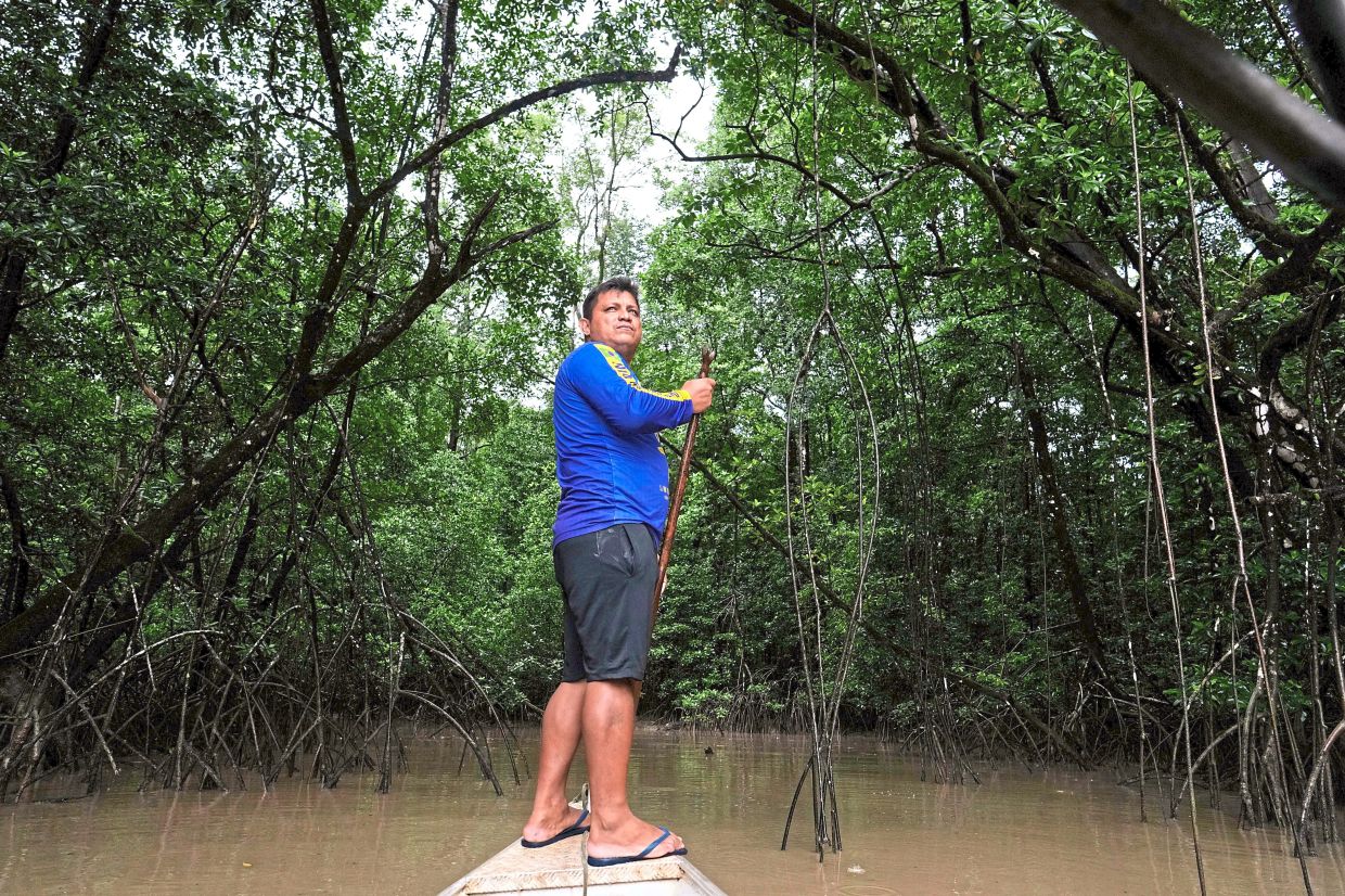 Edervan Forte dos Santos, from the Galibi Kali’na community, steering his boat towards the mangroves in the biodiversity conservation area of Cabo Orange in Oiapoque. — AP