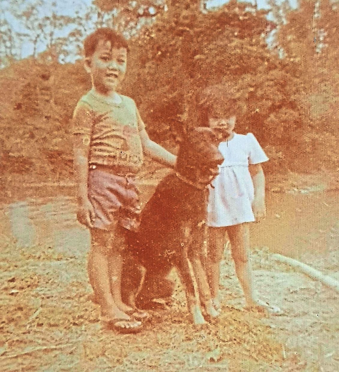 The writer (right) and his brother with their pet dog Hunter.