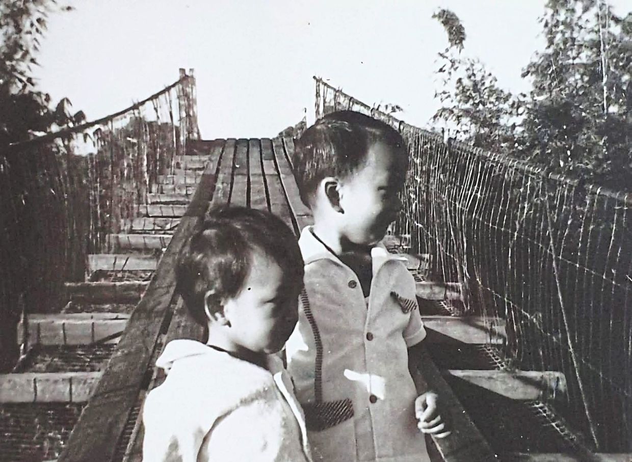The writer (left) and his brother in 1973 on the Tamparuli Suspension Bridge in Sabah.