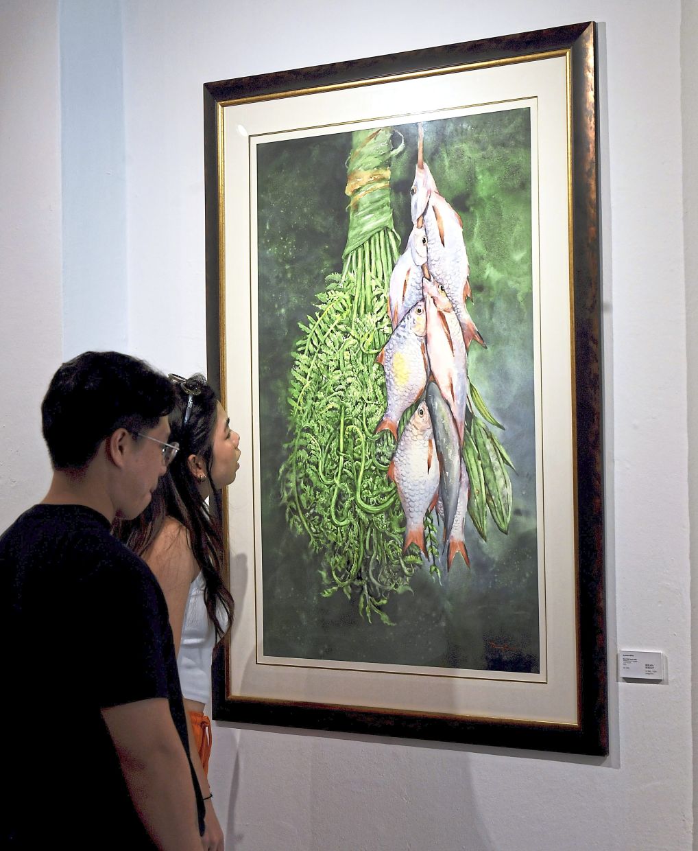 'Ikan Putih, Sayur Pakis', a watercolour on paper at the centre of the gallery, evokes Ryzalman’s kampung youth. Photo: The Star/Azhar Mahfof