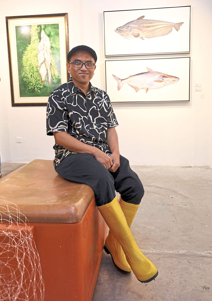 At the exhibition launch, Ryzalman took the wet market aesthetic all the way to his feet, arriving in rubber boots. Photo: The Star/Azhar Mahfof