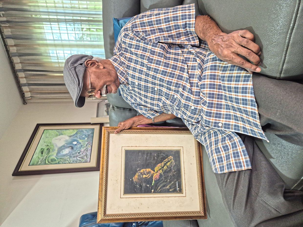 Sam with a painting of Malaysia's first prime minister, Tunku Abdul Rahman Putra Al-Haj, which he created at 15. Photo: The Star/Sheela Chandran