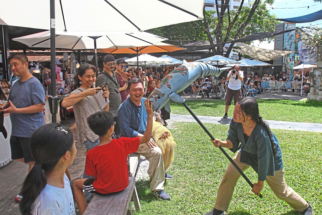 Puppeteers from Project Riwayat performing with Irawaddy dolphin puppets.