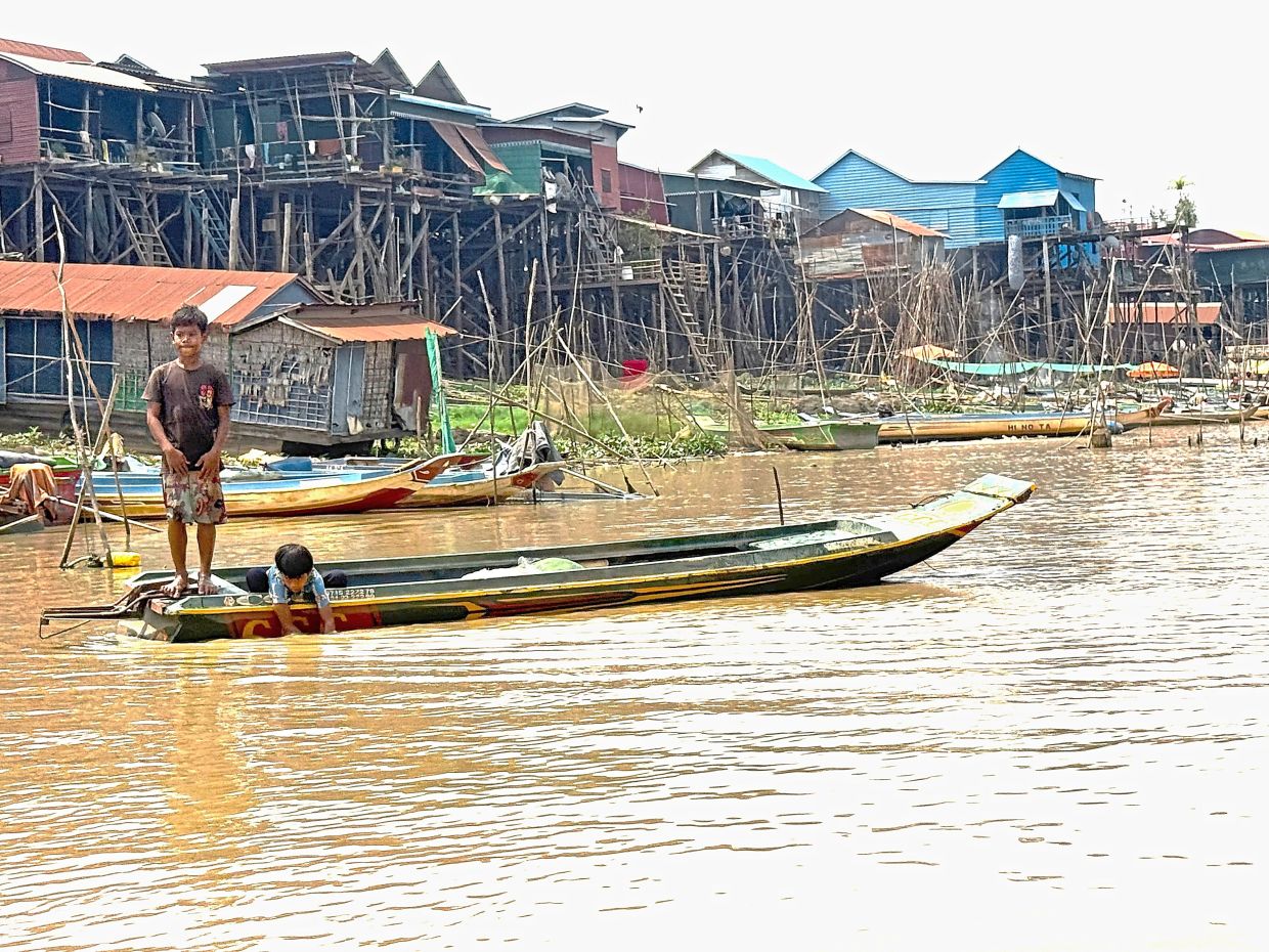 Children travel to school by boat on Tonle Sap.