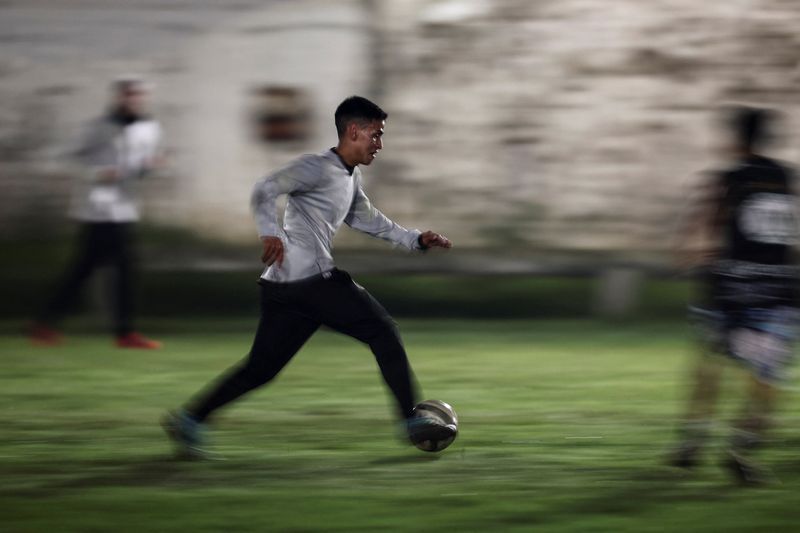 Amateur football games on Buenos Aires’ makeshift “potreros” are offering small but vital earnings for players like Emiliano Migueles, who balances sport with a delivery job.