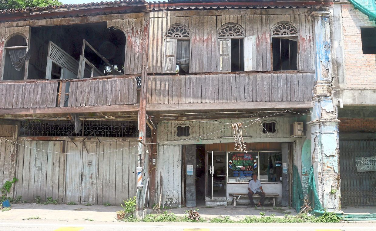 Gnasergaran cuts a lone figure outside his ageing shop.