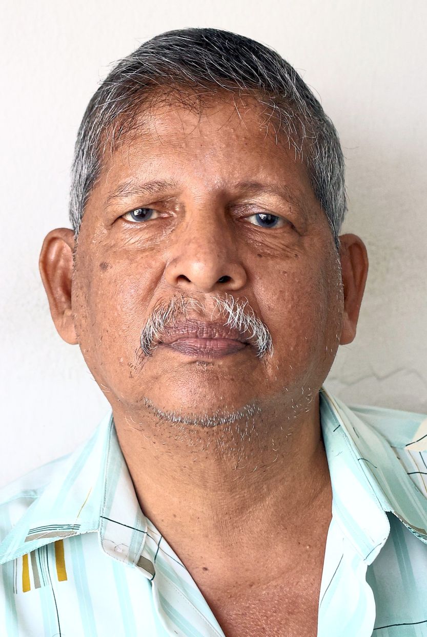 Ramasamy travels all the way from Gopeng to have his hair cut by his regular barber in Kampung Kepayang.