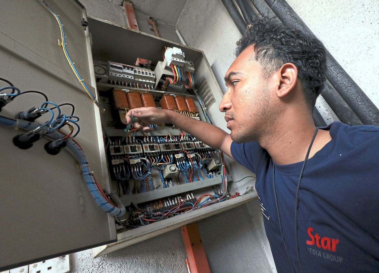 Muhammad Musraf carrying out maintenance work as part of his duties with the Building Property Services department at The Star.