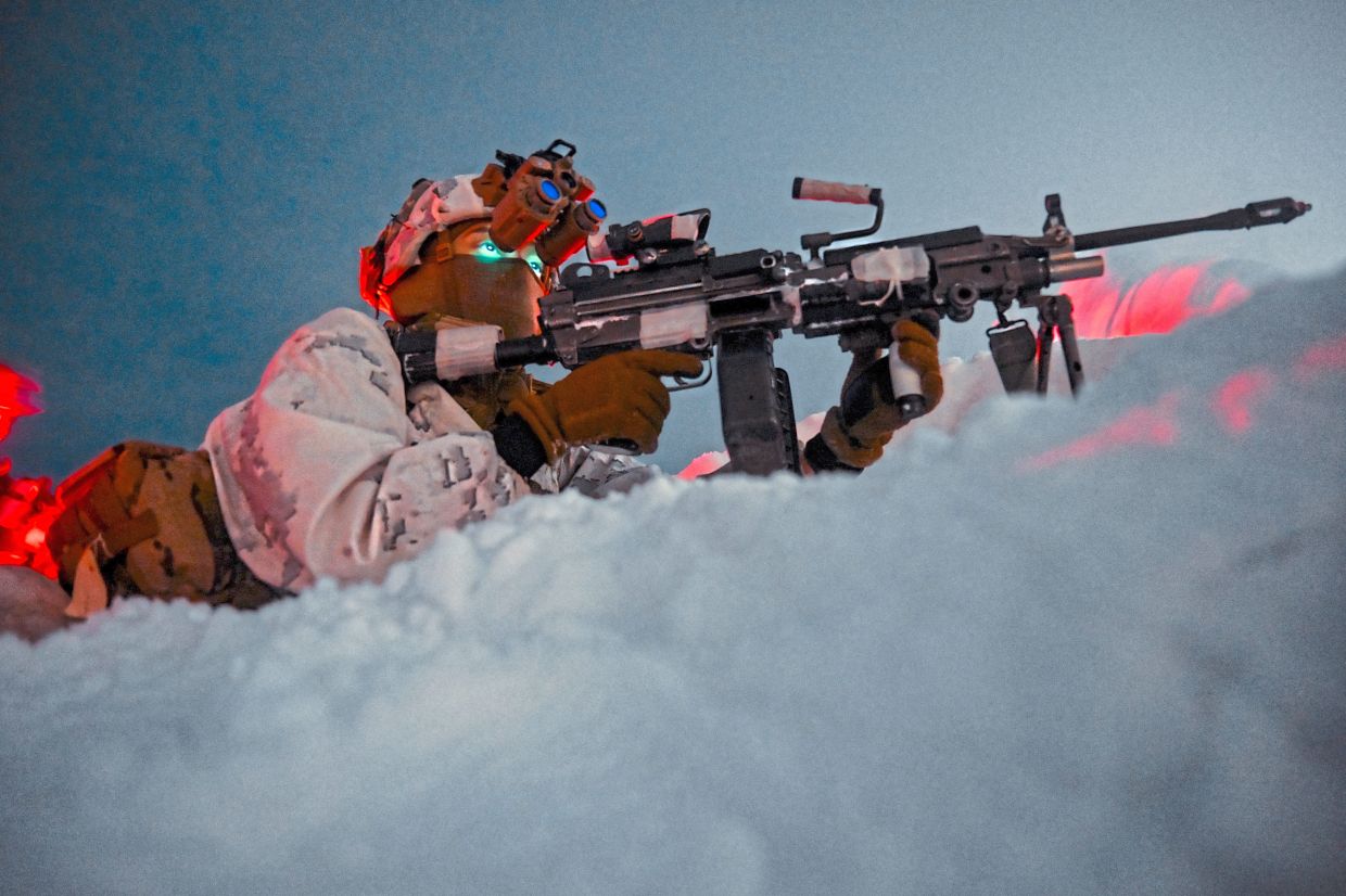 US Army Specialist James Alvarado gets into position during a night mission at the Yukon Training Centre in Alaska. — Kenny Holston/The New York Times