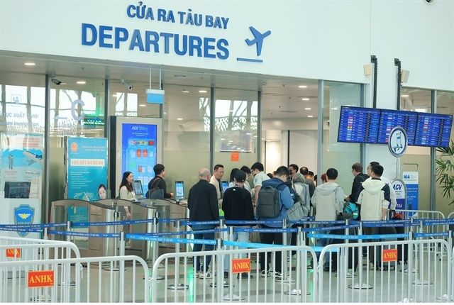 Passengers at the Noi Bai International Airport departures gate. Hanoi has placed aviation infrastructure at the centre of economic development rather than treating airports solely as transport hubs. - Photo: VNA/VNS