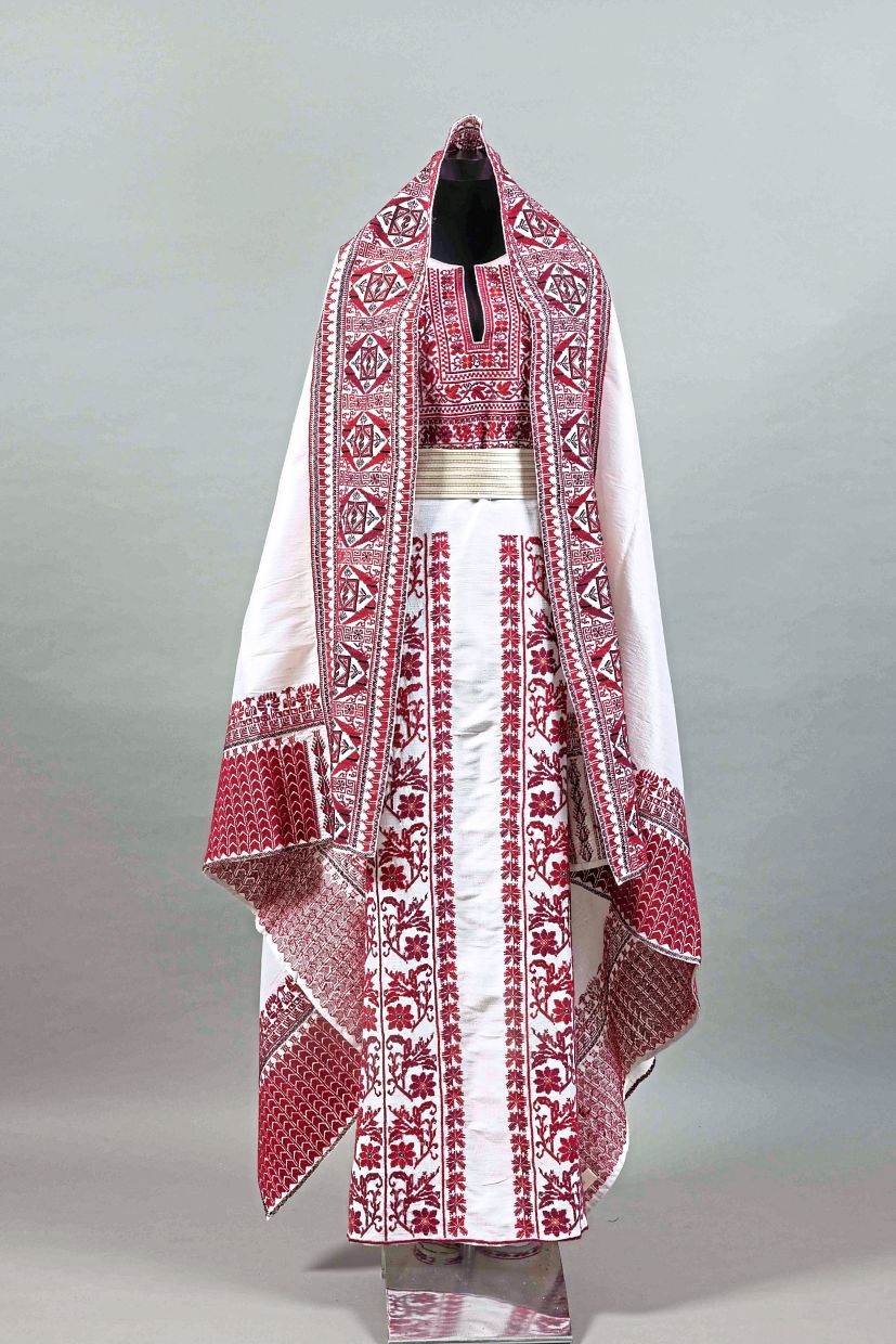 A silk wedding thobe (a traditional long robe) exhibit from Ramallah, featured in the 'Tatreez: Reclaiming Palestine Through Embroidery' show. Photo: IAMM