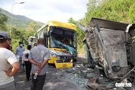 Three people seated at the front of the bus, including the d