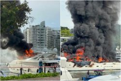 Luxury yacht at Singapore's Sentosa Cove marina catches fire; no reported injuries