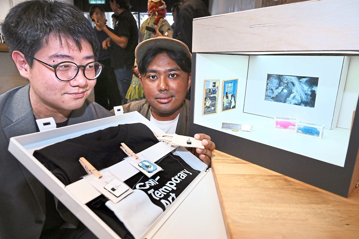 Con-Temporary Art artistic director B. Arrvinraj (right) and gallery director Joshua Kon giving a teaser of the small mobile art gallery that will tour the city during the festival. 