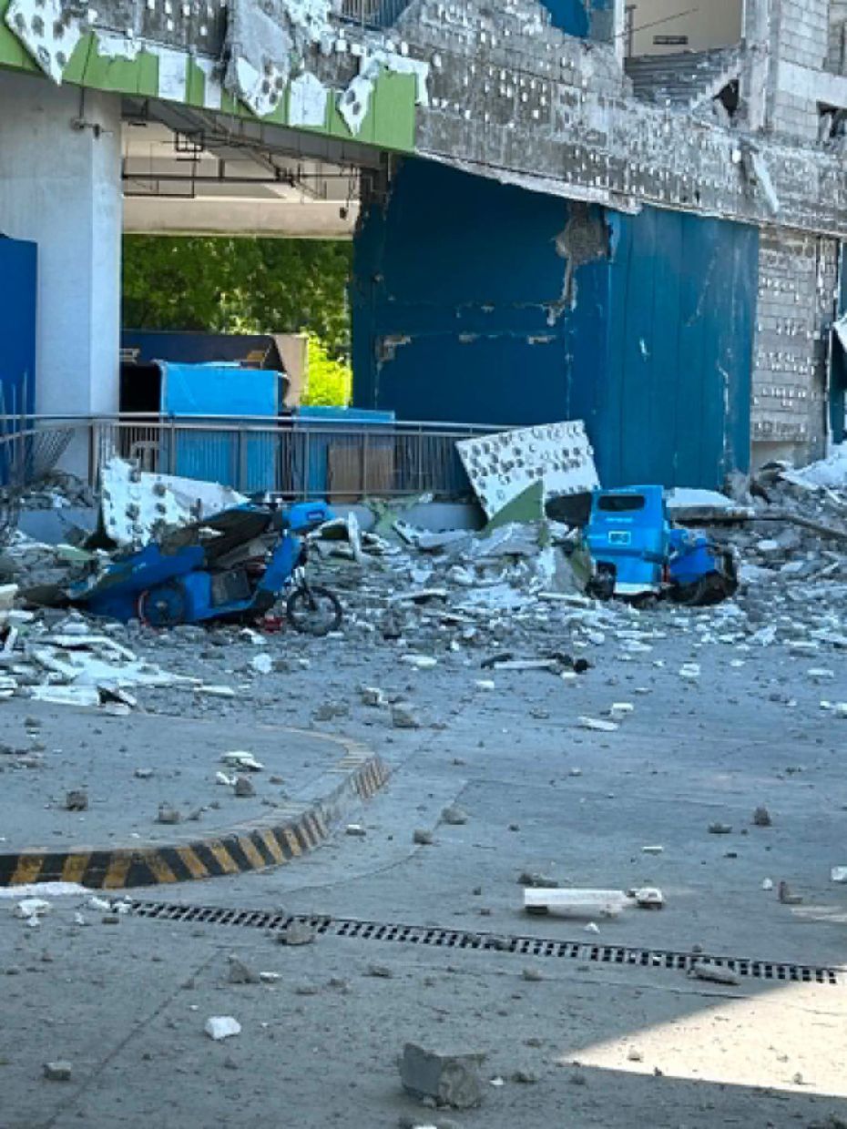 Vehicles damaged by debris after the powerful earthquake in the Mindanao region. - AP