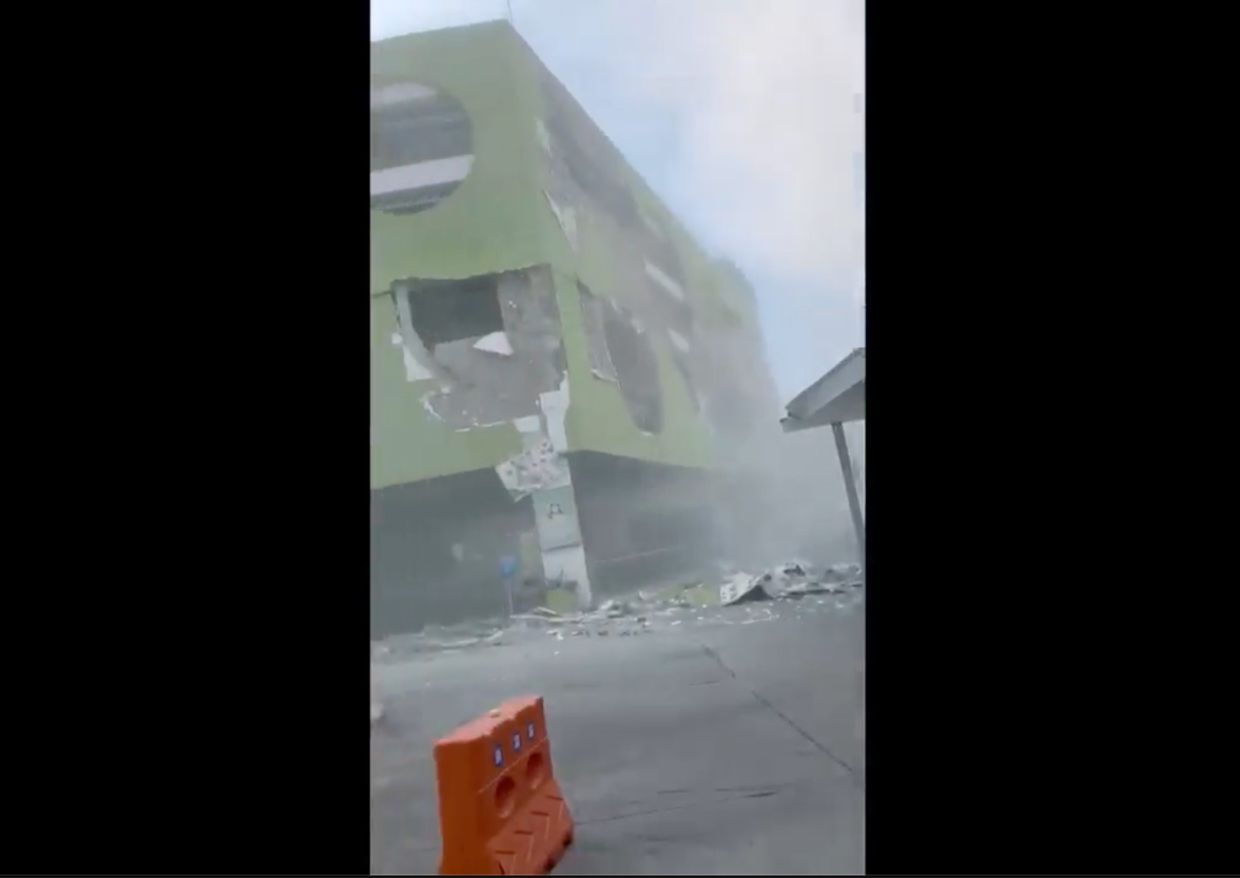 This image from a video shows dust and debris outside a building after the powerful earthquake in General Santos city on the island of Mindanao on June 8, 2026. - AP